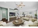 Bright living room with modern furnishings, including a sofa, ottoman, and decorative coffee table at 2534 N 73Rd Dr, Phoenix, AZ 85035