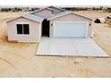 New home with a modern design, neutral colors, a two-car garage, and a concrete driveway at 25745 W Peak View Rd, Wittmann, AZ 85361