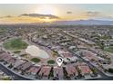 Gorgeous aerial view of a neighborhood with golf course, lake, desert landscaping and mountain views in the background at 2722 N 155Th Dr, Goodyear, AZ 85395
