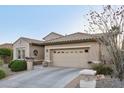 Front exterior view of a home with a two-car garage, desert landscaping, and a tile roof at 2722 N 155Th Dr, Goodyear, AZ 85395
