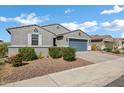 View of the front exterior featuring a well-manicured yard and grey facade, offering inviting curb appeal at 4140 E Caitlin Dr, San Tan Valley, AZ 85140