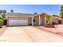 Single-story home with attached garage and desert landscaping in a quiet neighborhood at 4305 E Cherokee St, Phoenix, AZ 85044