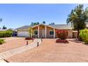 Inviting single-story home with low-maintenance desert landscaping and a brick-lined pathway at 4305 E Cherokee St, Phoenix, AZ 85044