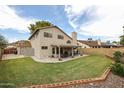 A spacious yard with a covered patio offers room for outdoor activities and relaxation at 4423 W Escuda Dr, Glendale, AZ 85308