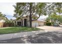 Charming two-story home with a spacious three car garage, lush lawn, and inviting entryway at 4423 W Escuda Dr, Glendale, AZ 85308