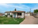 Exterior view of home showcasing the covered front porch and detached garage in a well-kept yard at 4630 N 12Th Pl, Phoenix, AZ 85014