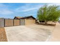 Spacious driveway and gated parking area with a clean exterior at 4810 W Kelton Ln, Glendale, AZ 85306