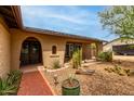 Welcoming front porch with desert landscaping, cacti, and a brick walkway at 4810 W Kelton Ln, Glendale, AZ 85306