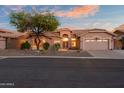 Attractive single-story home featuring mature desert landscaping, a two-car garage and tiled roof at 6339 S Palo Blanco Dr, Gold Canyon, AZ 85118
