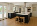 Bright kitchen features an island with bar seating, white cabinetry, and modern appliances at 6428 E Shea Blvd, Scottsdale, AZ 85254