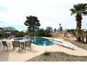 Backyard in-ground pool with diving board surrounded by mature palm trees at 6428 E Shea Blvd, Scottsdale, AZ 85254