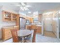 Cozy kitchen with stainless steel refrigerator and dining area near front door at 6721 E Mcdowell Rd # H324, Scottsdale, AZ 85257