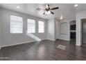 Bright living area featuring sleek floors, neutral walls, and ample natural light from multiple windows at 7336 S 48Th Gln, Laveen, AZ 85339