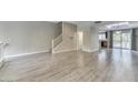 Open-concept living room with wood-look tile flooring and abundant natural light at 815 E Rose Ln # 105, Phoenix, AZ 85014