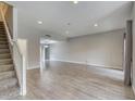 Spacious living room with wood-look tile flooring and recessed lighting at 815 E Rose Ln # 105, Phoenix, AZ 85014