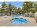 Inviting community pool and hot tub surrounded by mature trees and lounge chairs for relaxation and enjoyment at 860 N Mcqueen Rd # 1213, Chandler, AZ 85225