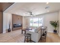 Inviting living room with modern fireplace, comfortable seating, stylish decor, and a large window at 8602 E Whitton Ave, Scottsdale, AZ 85251