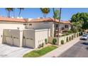 Inviting two-story home with a three-car garage, well-maintained lawn, desert landscaping, and palm trees at 8841 S 51St St # 1, Phoenix, AZ 85044