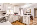 Bright eat-in kitchen featuring white cabinets, stainless appliances, and an arched window at 910 W Redondo Dr, Gilbert, AZ 85233