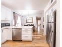 Bright kitchen with stainless steel appliances, white cabinets, and a breakfast bar at 910 W Redondo Dr, Gilbert, AZ 85233