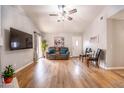 Cozy living room with a comfortable couch, hardwood floors, and a ceiling fan at 910 W Redondo Dr, Gilbert, AZ 85233