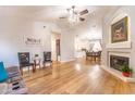 Spacious living room features a fireplace, hardwood floors, and an elegant chandelier at 910 W Redondo Dr, Gilbert, AZ 85233
