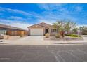 Inviting single-story home featuring a two-car garage and desert landscaping at 947 E Wiley Way, Casa Grande, AZ 85122