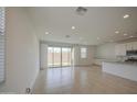 Bright, open living space featuring a large sliding glass door to the backyard at 9923 E Tahoe Ave, Mesa, AZ 85212