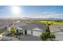 Scenic aerial view of the home showcasing its well-manicured landscaping and panoramic mountain views in a desirable community at 11656 N San Clemente St, Surprise, AZ 85388