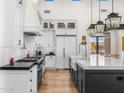 Bright kitchen with large island, white cabinets, modern appliances, and designer fixtures at 12633 N 81St St, Scottsdale, AZ 85260