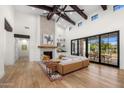 Open living room with high ceilings, fireplace and sliding glass doors to backyard at 12633 N 81St St, Scottsdale, AZ 85260