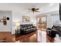 Bright living room featuring shiny floors, ceiling fan, and patio access at 14645 N Fountain Hills Blvd # 208, Fountain Hills, AZ 85268