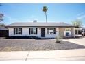 Charming single-story home features desert landscaping, a carport, and a well-maintained exterior at 1633 E Wesleyan E Dr, Tempe, AZ 85282