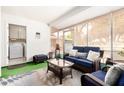 Cozy sunroom with a blue sofa, wicker furniture, and a view of the backyard at 17822 N Del Webb Blvd, Sun City, AZ 85373