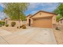 Attractive single-level home with drought-tolerant landscaping, a two-car garage, and neutral tones at 18374 W Stinson Dr, Surprise, AZ 85374