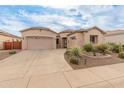 Charming single-Gathering home with a three car garage and beautiful desert landscaping on a bright day at 20289 N 259Th Ave, Buckeye, AZ 85396