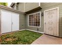 Inviting entrance to a home with a secure gate, well-maintained lawn, and convenient storage at 2301 E University Dr # 393, Mesa, AZ 85213