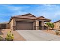Single-story home featuring a two car garage, landscaped yard and covered porch at 23728 W Magnolia Dr, Buckeye, AZ 85326