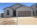 New construction home with a desert-style front yard and a two-car garage at 24233 W Hidalgo Ave, Buckeye, AZ 85326