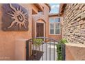 Inviting front entrance with custom iron gate and courtyard landscaping at 27926 N 130Th Ave, Peoria, AZ 85383