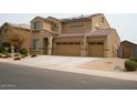 Charming two-story home with a three-car garage and low-maintenance desert landscaping at 2917 S 121St Ln, Tolleson, AZ 85353