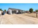A well-maintained home featuring a concrete driveway and modern exterior paint scheme at 3320 E Claire Dr, Phoenix, AZ 85032