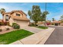 Inviting two-story home with a well-manicured lawn, mature tree, and a spacious driveway at 3832 N Gallatin --, Mesa, AZ 85215