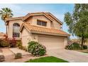 Front exterior showing beautiful landscaping, tile roof, and spacious two car garage of this lovely home at 3832 N Gallatin --, Mesa, AZ 85215