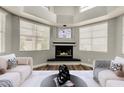 Cozy living room with a fireplace and large windows providing ample natural light at 3832 N Gallatin --, Mesa, AZ 85215