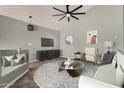 Bright living room featuring modern decor, a round window, and a ceiling fan at 3832 N Gallatin --, Mesa, AZ 85215