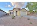 Inviting single-level home featuring a well-kept front yard and a convenient two-car garage at 40054 W Tamara Ln, Maricopa, AZ 85138