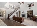 Bright living room featuring high ceilings, large staircase, stone fireplace, and an open layout for modern living at 4125 W Lydia Ln, Phoenix, AZ 85041