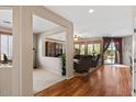 Open-concept living room with hardwood floors, neutral paint, plantation shutters, and ample natural light at 4517 E Sourwood Dr, Gilbert, AZ 85298