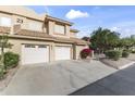 Condo building featuring attached garages, desert landscaping, and red tile roofing at 5450 E Mclellan Rd # 145, Mesa, AZ 85205